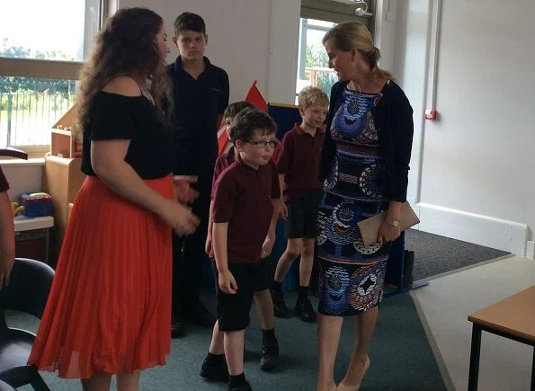 The Countess of Wessex wore a Body Con Reptile Moth Print Jersey Dress by Alexander Mcqueen while visiting the Mendip School and Gianvito Rossi pumps