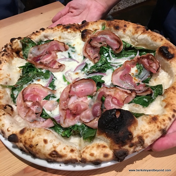 spinach-pancetta pizza at Benchmark Oakland in California spinach-pancetta pizza at Benchmark Oakland in California