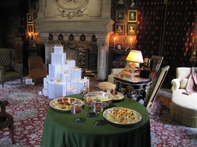 The salon at Chateau Azay-le-Rideau set out for Christmas with table settings of chocolates and sweets