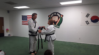 Taekwondo Martial Art Lady Recieving Black Belt Taekwondo martial art lady recieving her new black belt