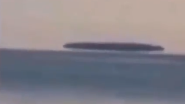 Huge-Mothership-UFO-hovering-just-above-the-water-of-Lake-Michigan.