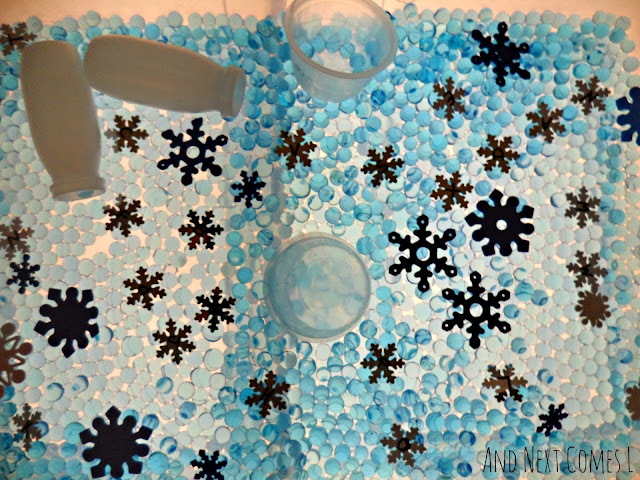 Winter sensory bin with water beads and snowflakes