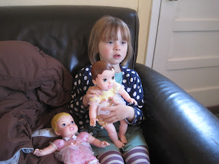 Little girl and two dolls