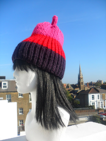 NEW IN .WRAP UP WARM IN STRIKING STRIPES PEAR HAND-KNIT HAT .*BY FLORA LYIMO DESIGNER*