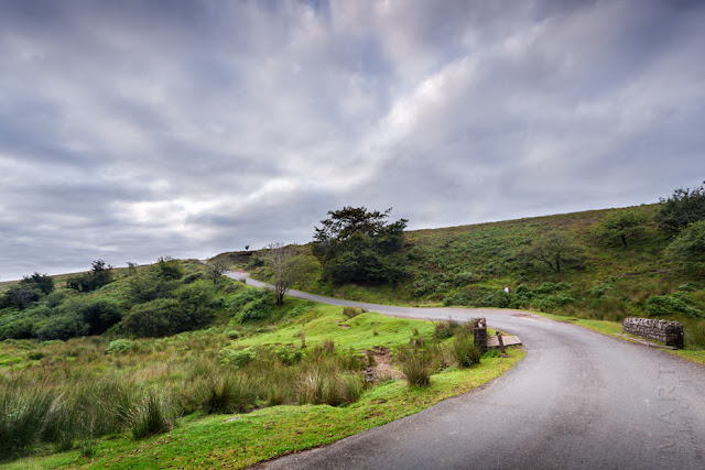 A small lane winds over the Exmoor landscape under cloud by Martyn Ferry Photography