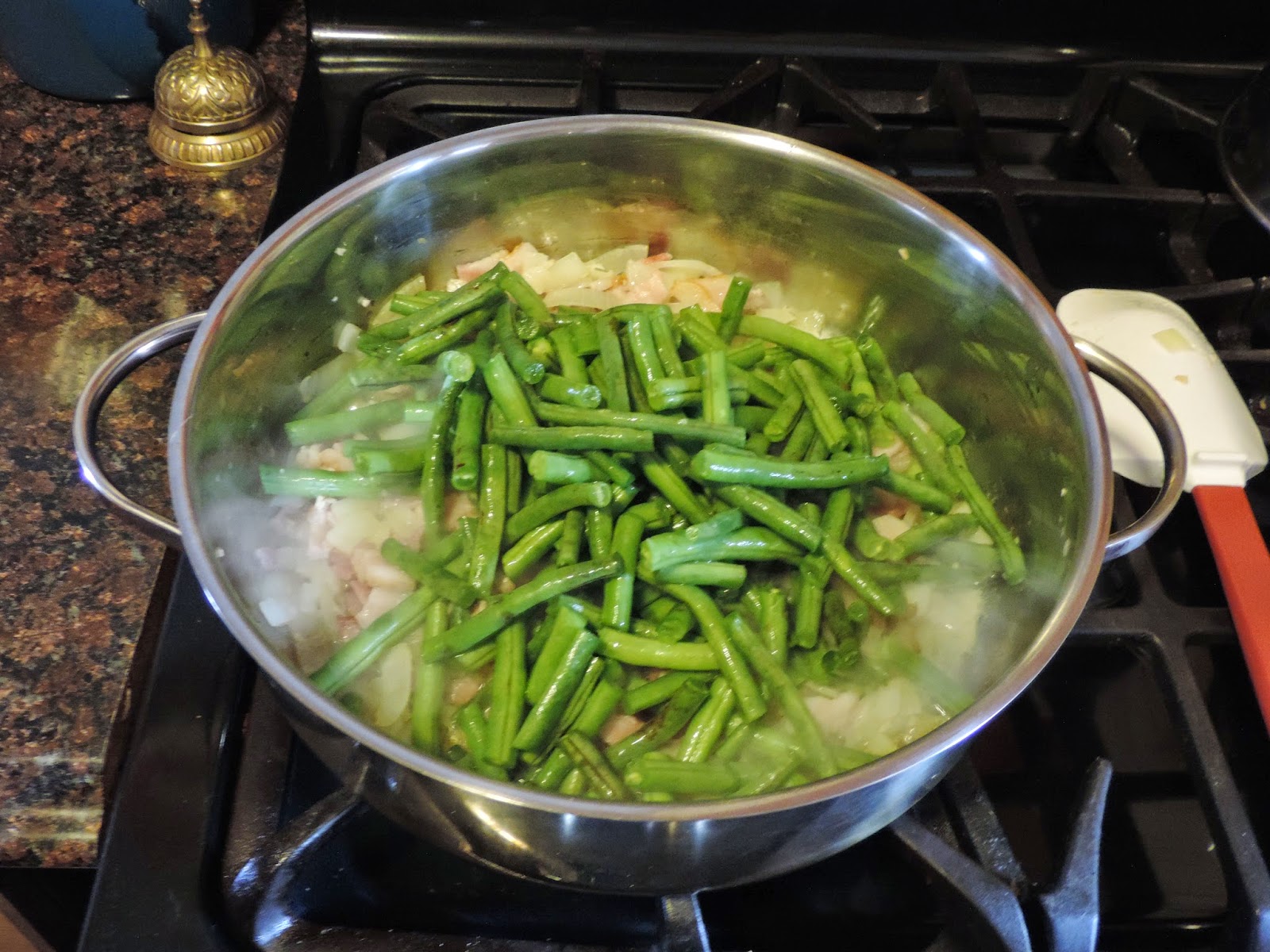 The green beans being added to the pan. 