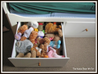 teddy bears dolls and stuffies in a drawer