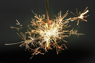 a sparkler in a night-time background