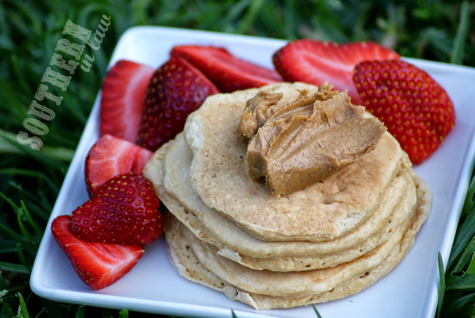 Cold Healthy Buttermilk Pancakes Topped with Peanut Butter and Strawberries