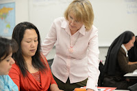 Image of a Rio instructor offering guidance to students in a student lab