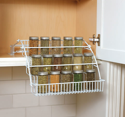 spice rack inside a cabinet; rack pulls down for easy access
