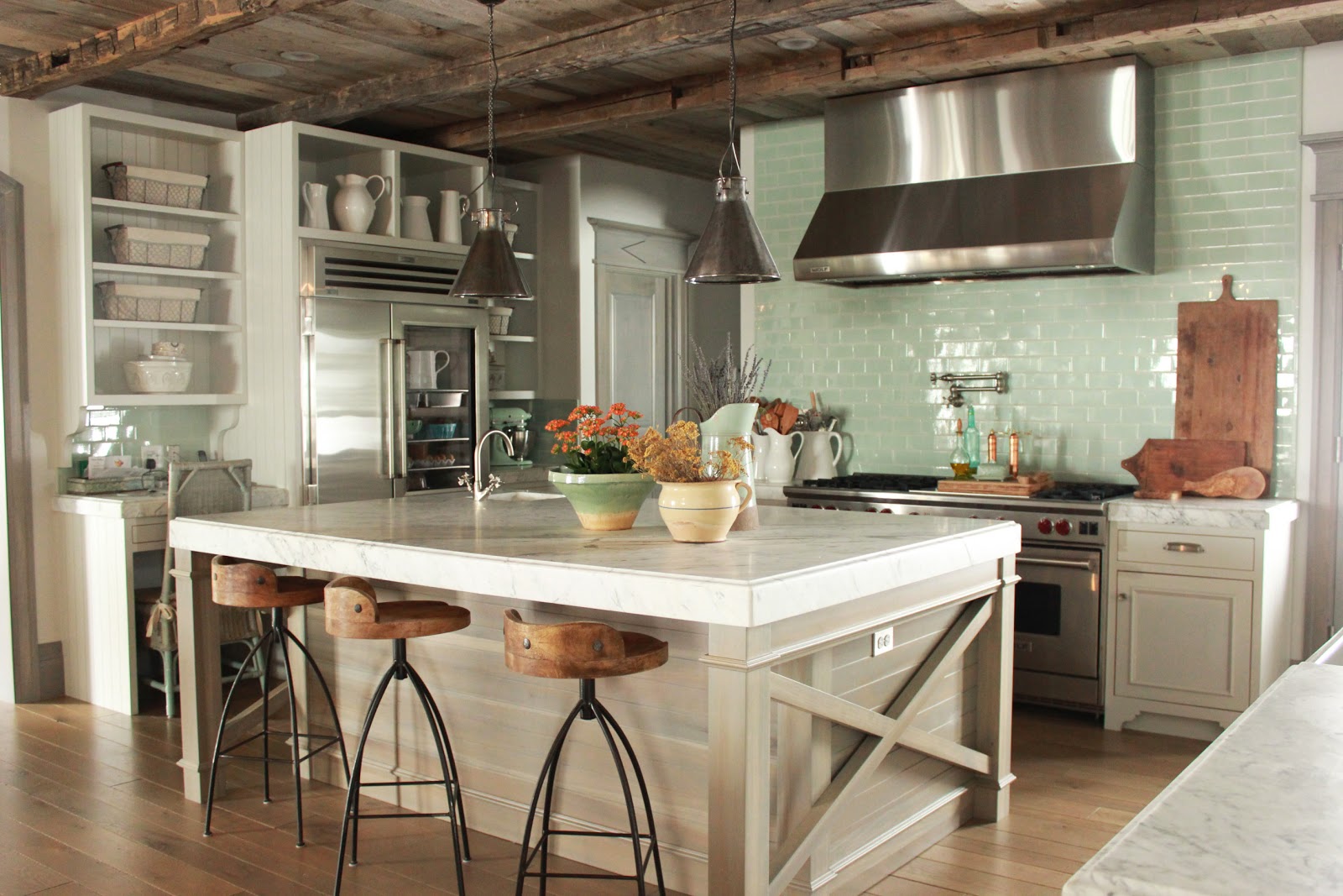 Magnificent Gustavian French kitchen in stone cottage with rustic interiors, reclaimed wood ceilings, blue-grey, green, and collected European antiques. Designed by Desiree Ashworth. Find ideas for grey, blue, and green paint colors.