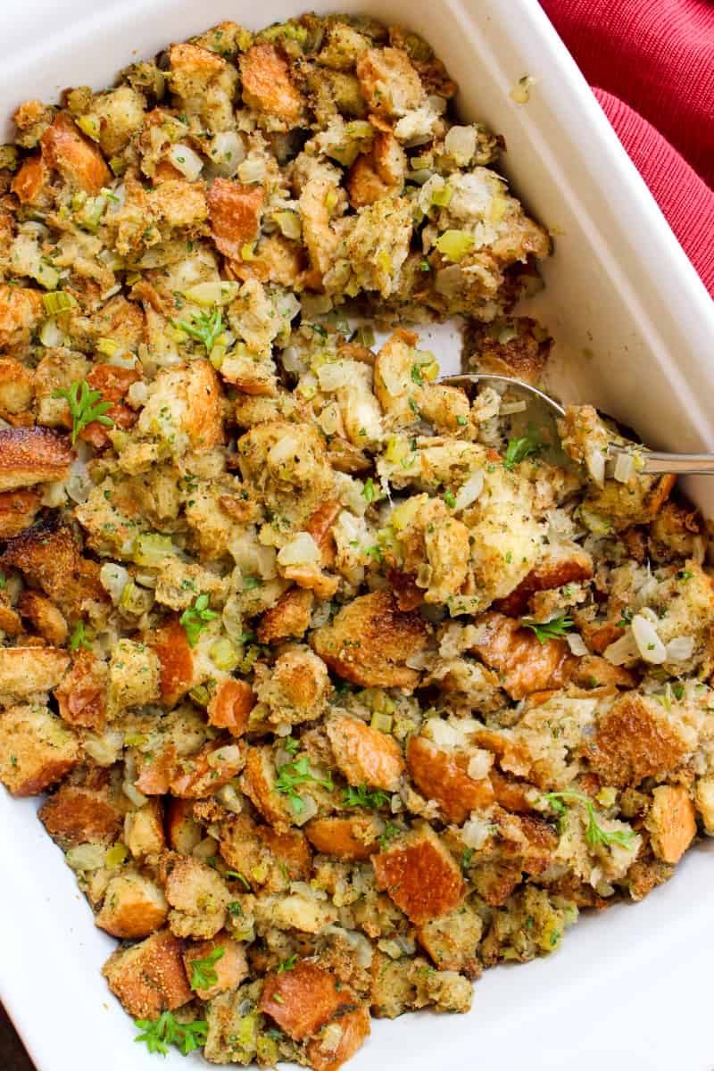 This Traditional Stuffing recipe has the classic flavors of the holidays that you know and love!  Made with fresh bread cubes, onions, celery, and fresh herbs, it's an easy to make recipe that you'll want to make every year! #stuffing #thanksgiving #sidedish