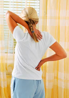 Woman with Upper Back Pain in Need of a Massage Therapist