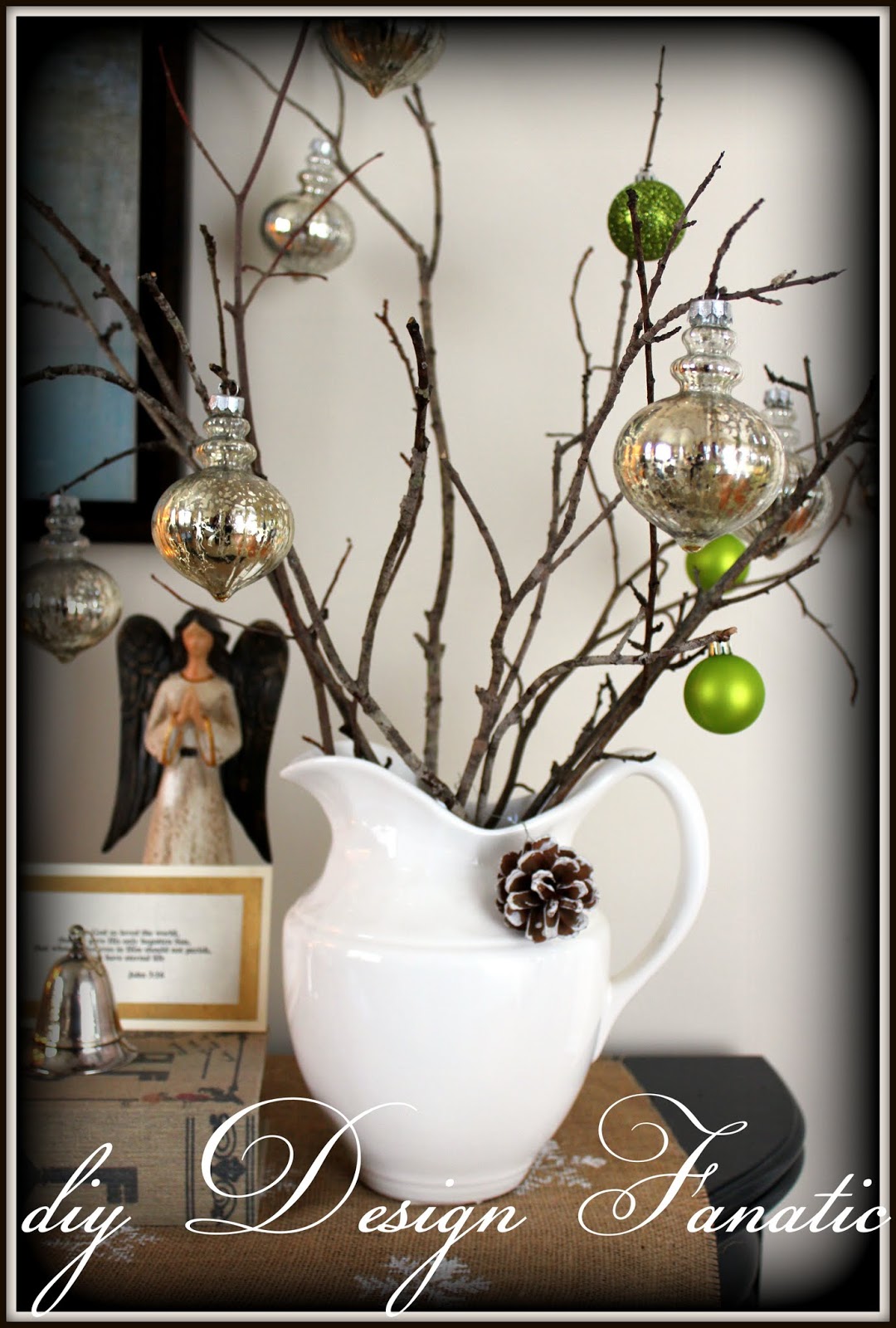 Bare branches collected from our yard hold silver and green ornaments.