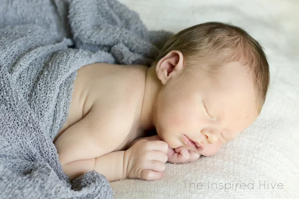 Our natural birth story- a quick labor with a surprising ending. Grey newborn wrap photography.