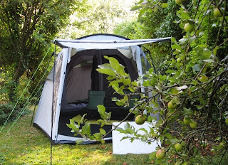 Our huge tent nestling among apple trees and large bushes