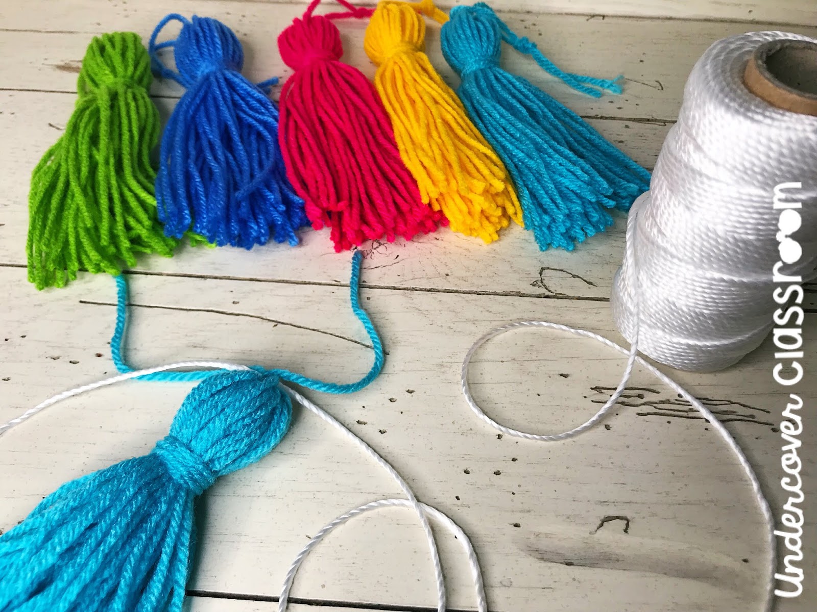 Spruce up your classroom with this DIY tassel garland. Follow these easy steps to make yarn tassels. It's easier than you think. Your bulletin boards will be looking jazzy in no time!