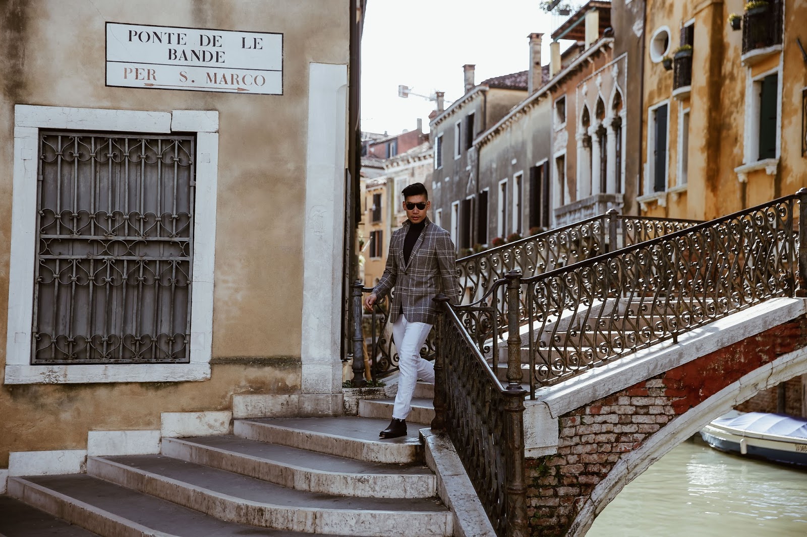 Leo Chan wearing a blazer with jeans in Venice, Italy 