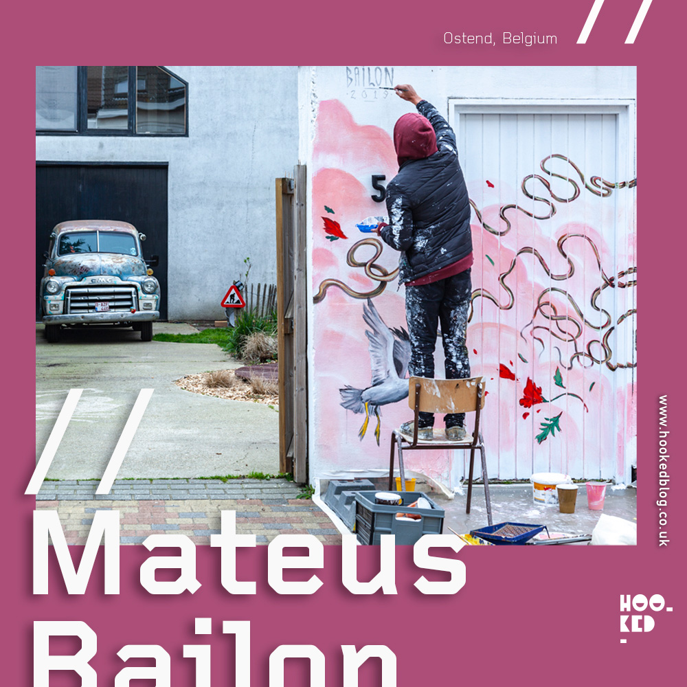 Artist Mateus Bailon on a chair painting a New Mural in Ostend