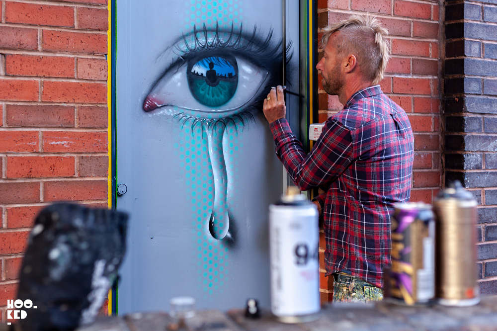 Street Artist My Dog SIghs at work in Cheltenham, UK for the Cheltenham Paint Festival