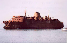 The charred wreck of the Moby Prince pictured  in the days after the tragedy that claimed 140 lives