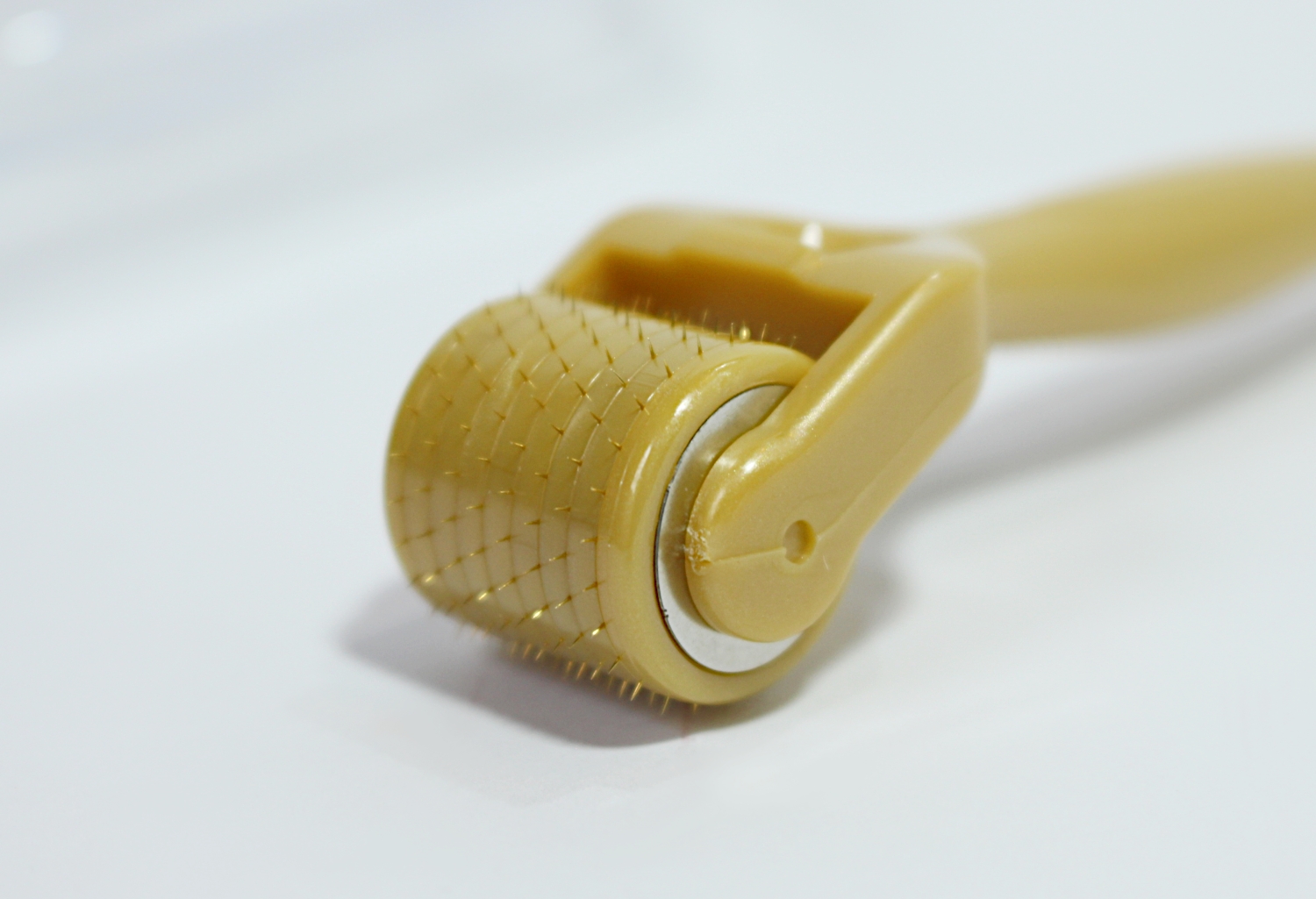 a close-up of derma roller tool on a plain, white studio's background