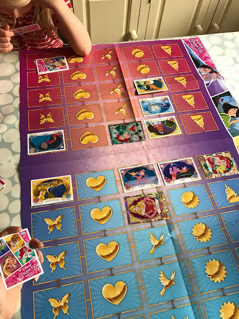 An image of the games mat with some cards on.