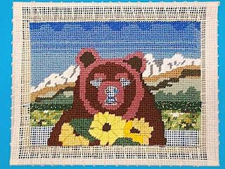 Bear and sunflowers with near background detail