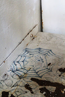 Spider web drawn on a metal desk in a prison cell