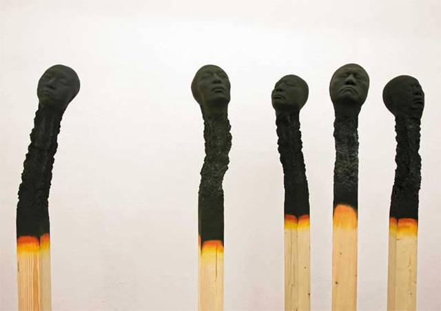 German artist Wolfgang Stiller acquired several head molds and large pieces of wood. After experimenting with the various components the artist struck on an idea to create several large-scale burnt matches where the charred remains of each tip appeared as the face of a human, a series he calls Matchstickmen