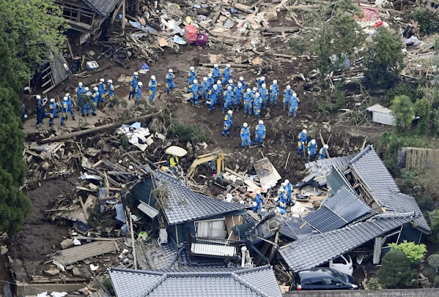 Rescue workers conduct a search and rescue operation to a collapsed house at a landslide site caused by earthquakes in Minamiaso town, Kumamoto prefecture, southern Japan, in this photo taken by Kyodo April 16, 2016. Mandatory credit   REUTERS/Kyodo