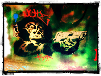 Graffiti showing chimp holding pistol