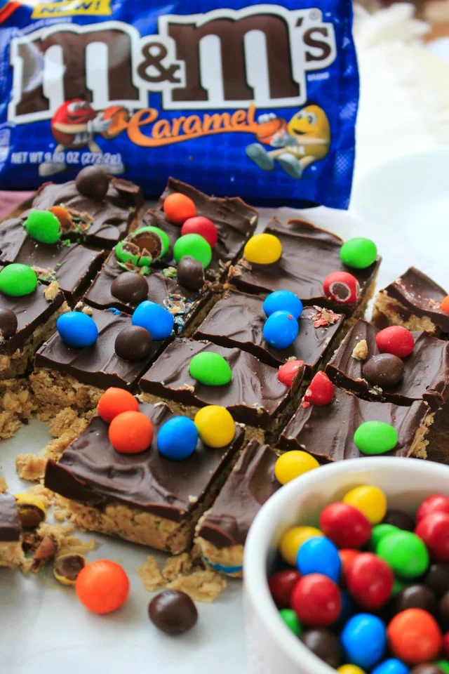 Chocolate Caramel Oatmeal Cookie Bars are a delicious no-bake sweet treat made with a fudge-like oatmeal cookie base, a silky chocolate topping, and lots of M&M’S® Caramel! #UnsquareCaramel #AD