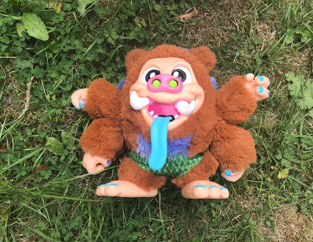 Snort Hog Crate Creature toy on grass 