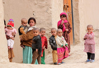 A number of handful Afghani children looking at the camera