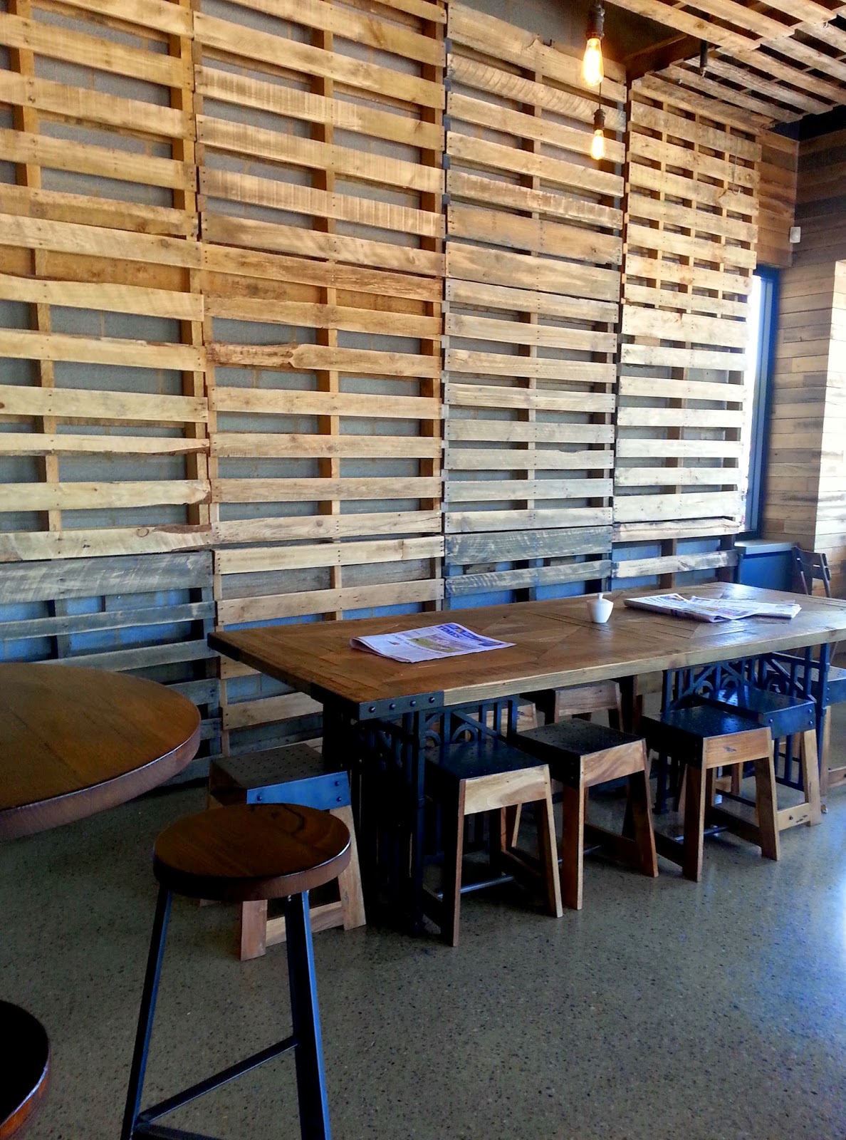 Interior of Coffee Lab cafe, with walls lined with pallets.