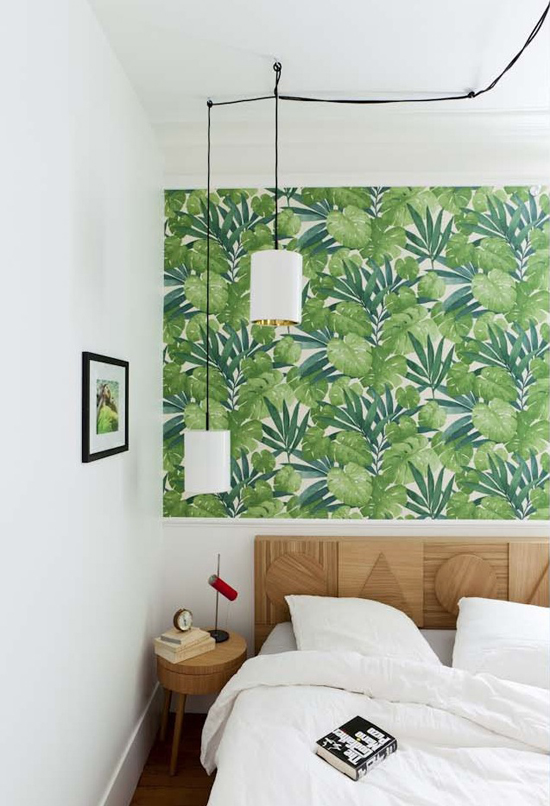 Fresh bedroom with a green tropical wallpaper