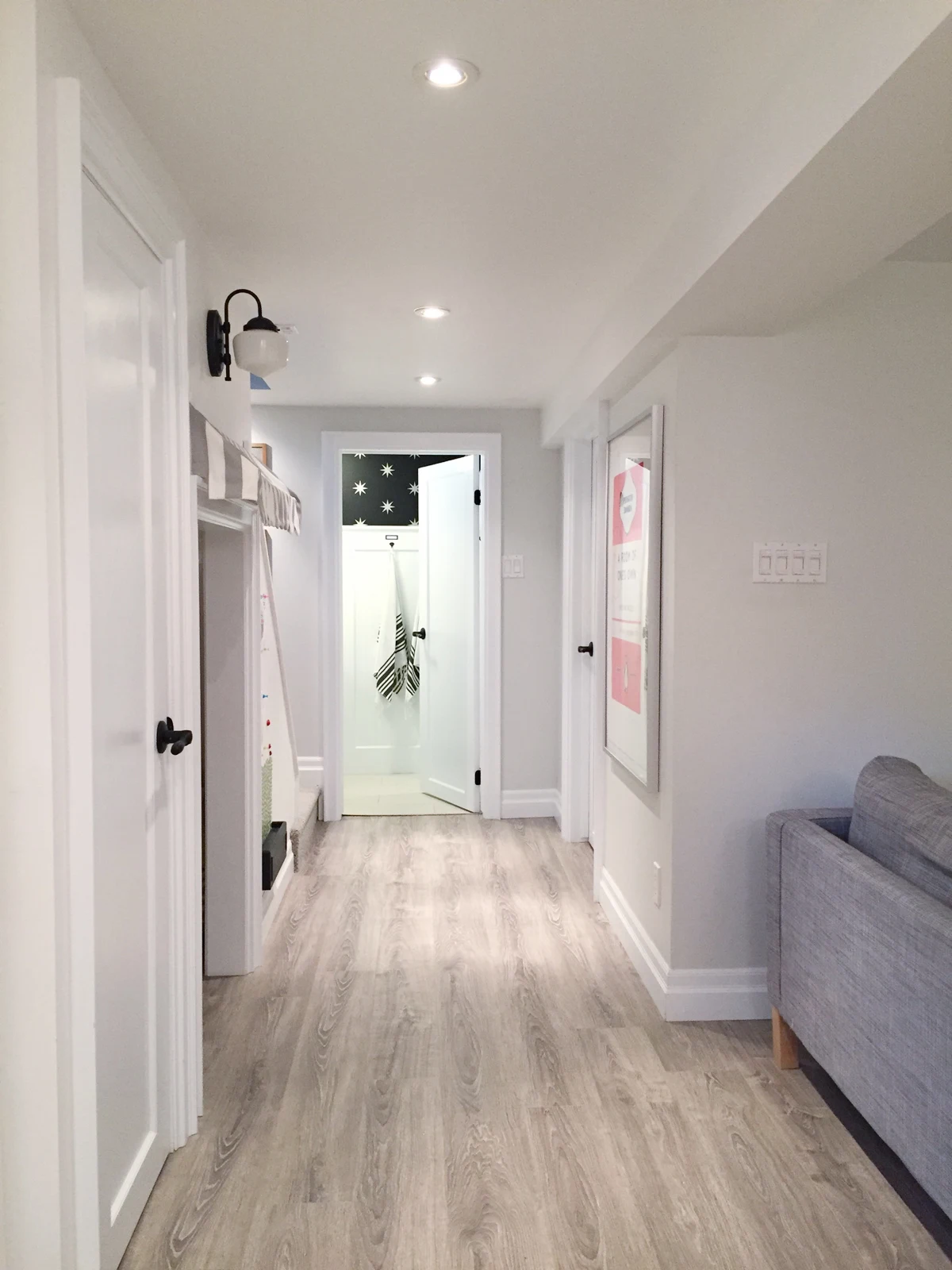 bright white basement | Kamina Oak laminate | ramblingrenovators.ca