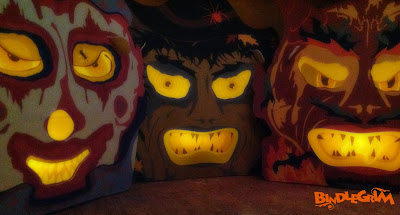 A clown, witch, and devil glow in the dark created as vintage style slot-and-tab candy container lanterns by holiday artist Bindlegrim