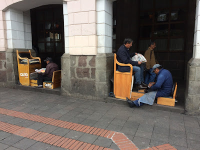 shoeshine vendors in the archway of the Archibishops palace, Quito