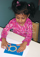young girl works with montessori sandpaper letters the history of montessori