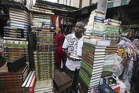A man sells copies of the Quran,