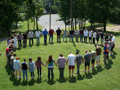 large circle of people holding hands at EMR