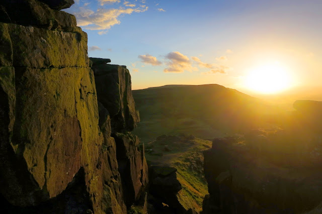 The setting sun producing a warm evening glow on the Wainstones 