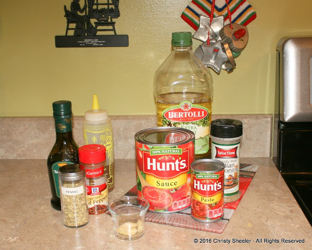 All the ingredients for pizza sauce are set out on the counter.