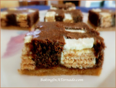 Kit Kat Brownie Bars: Mini white chocolate covered Kit Cats baked in a brownie center with a shortbread crust | Recipe developed by BakingInATornado.com | #recipe #bake #chocolate