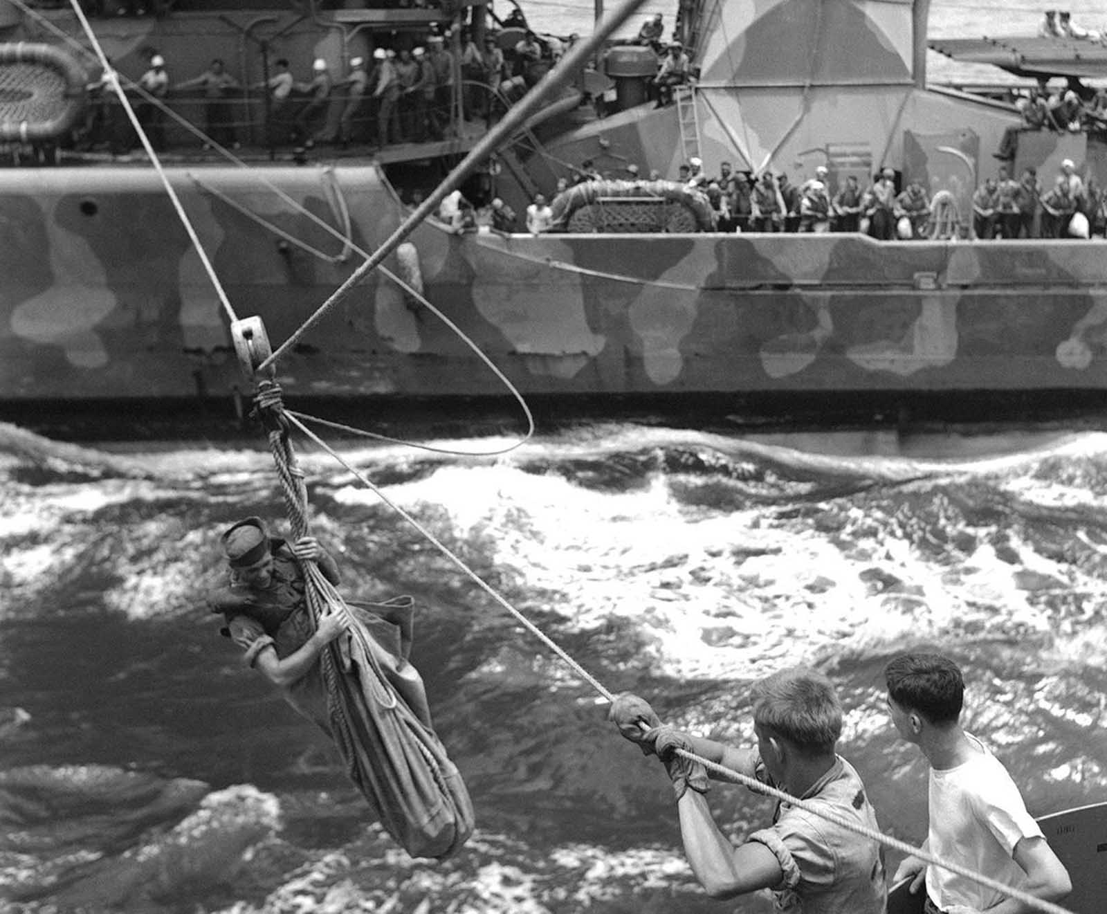 A breeches buoy is put into service to transfer from a U.S. destroyer to a cruiser survivors of a ship, November 14, 1942 which had been sunk in naval action against the Japanese off the Santa Cruz Islands in the South pacific on October 26. The American Navy turned back the Japanese in the battle but lost an aircraft carrier and a destroyer.