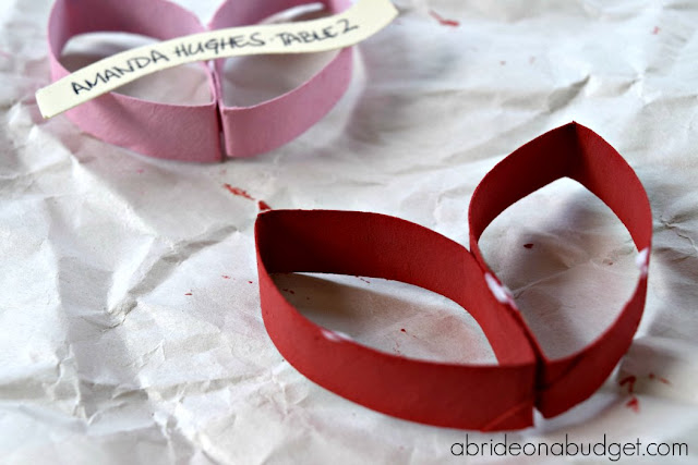 Who loves upcycling?  Check out these cute DIY heart escort cards made from toilet paper rolls by www.abrideonabudget.com.