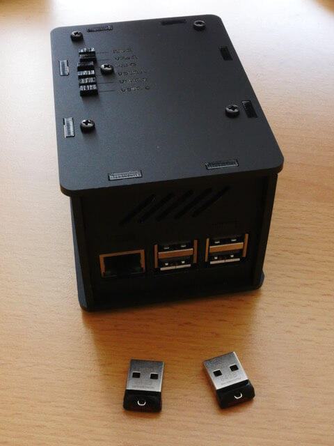 New Pi in its housing, along with the 64GB USB flash drives.